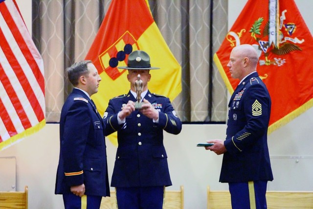 Drill Sergeant (Staff Sgt.) Brandon Briggs (center), A/1-31st FA, is recognized as the Drill Sergeant of the Cycle during the BCT graduation April 17, 2020, at Cache Creek Chapel. He was honored for his outstanding professionalism, competence, and...