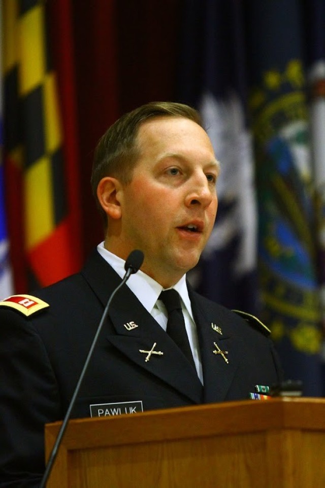 Capt. Aleksandr Pawluk, A/1-31st FA commander, congratulates  the Soldiers in his battery during Basic Combat Graduation April 17, 2020, at Cache Creek Chapel. He said they have courageously joined the Army during this dangerous time in history.