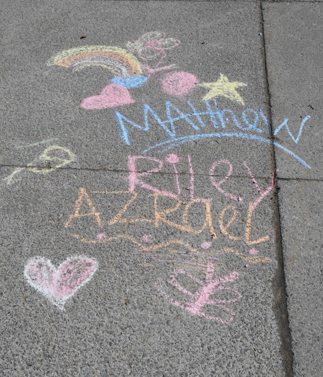 To celebrate Month of the Military Child, children at the Fort Drum School Age Center and Chapel Child Development Center participated in a sidewalk chalk art project April 20. (Photo by Mike Strasser, Fort Drum Garrison Public Affairs)