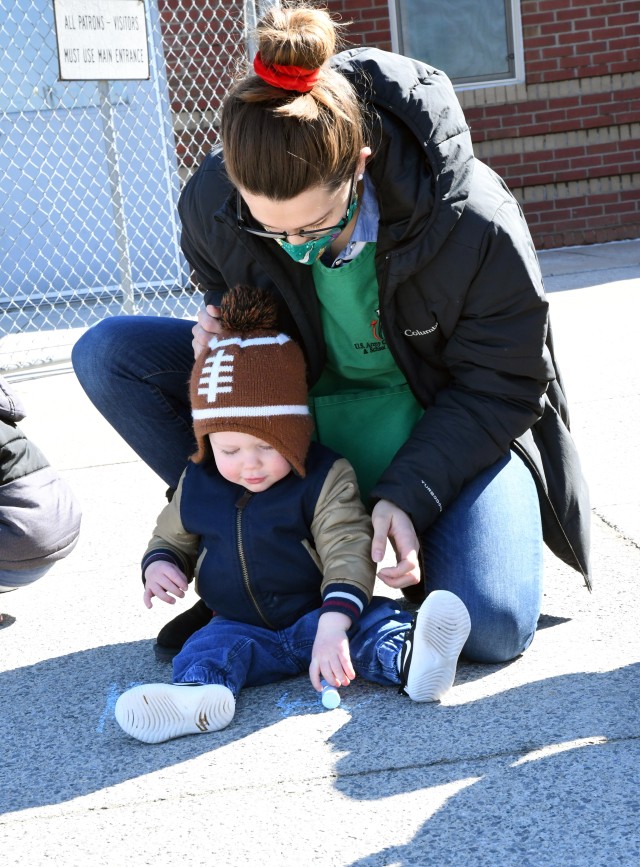 To celebrate Month of the Military Child, children at the Fort Drum School Age Center and Chapel Child Development Center participated in a sidewalk chalk art project April 20. (Photo by Mike Strasser, Fort Drum Garrison Public Affairs)