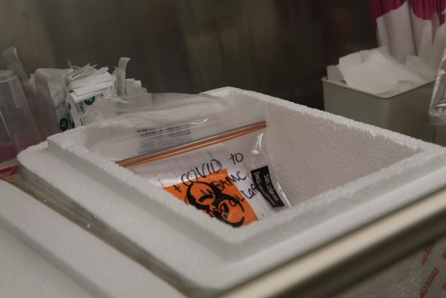 SGT Michael Estrada, medical lab technician, preps samples in the hospital lab to be transported to BSL3. (U.S. Army Courtesy photo by: Amabilia Payen, WBAMC Public Affairs.)