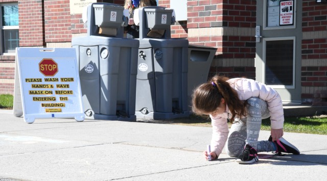 To celebrate Month of the Military Child, children at the Fort Drum School Age Center and Chapel Child Development Center participated in a sidewalk chalk art project April 20. (Photo by Mike Strasser, Fort Drum Garrison Public Affairs)