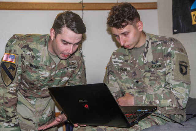 U.S. Army Sgt. Christopher Marinucci, left, and Spc. John Fiolich, right, Dealer Company, 1st Battalion, 506th Infantry Regiment, 1st Brigade Combat Team “Bastogne”, 101st Airborne Division (Air Assault), teaching an enemy vehicle identification course virtually to their unit within Spc. Fiolich’s barracks room on Fort Campbell, Kentucky. Due to COVID-19 Soldiers are executing social distancing procedures while sustaining readiness by executing courses through virtual learning and practical exercises. U.S. Army photo by Maj. Vonnie Wright.