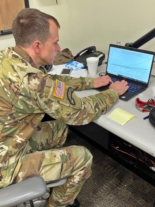 Lt. Col. Nick Clark, an assistant professor in the department of mathematical sciences, working on a mathematical model forecasting the impact of COVID-19 as part of his work augmenting Army North's response to the pandemic.