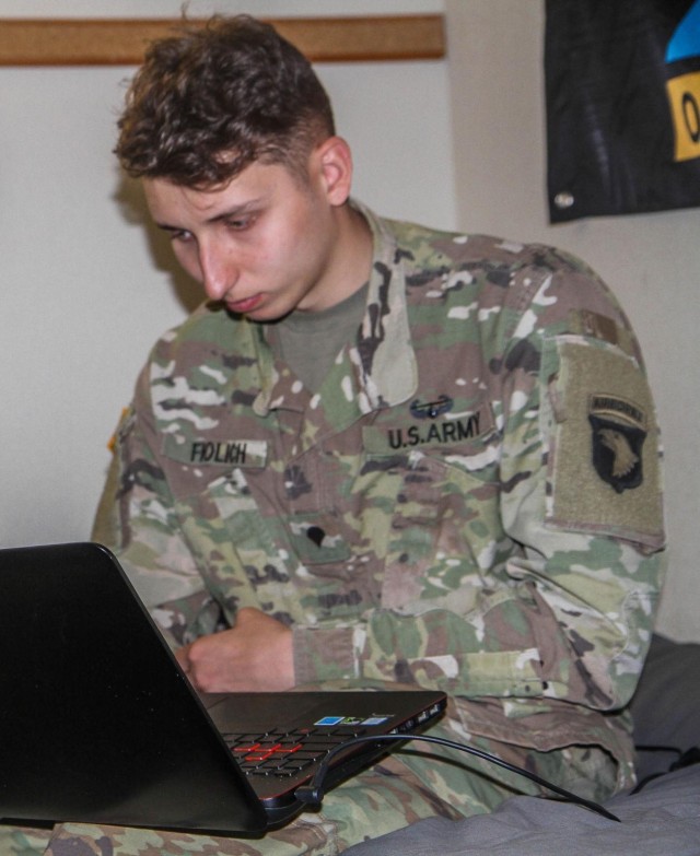 Spc. John Fiolich, D Company, 1st Battalion, 506th Infantry Regiment, 1st Brigade Combat Team,101st Airborne Division (Air Assault), teach an enemy vehicle identification course virtually to Soldiers in their unit in Fiolich’s barracks room. Because of the COVID-19, Soldiers are following social distancing protocols while sustaining readiness by through virtual learning and practical exercises. (U.S. Army photo by Maj. Vonnie Wright I 1st Brigade Combat Team)