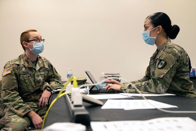 Army Spc. Ashlie Chandler, a behavioral health specialist at the Javits New York Medical Station, talks with a Soldier in the facility’s Behavioral Health Outpatient Clinic in support of the Department of Defense COVID-19 response, April 18, 2020. U.S. Northern Command, through U.S. Army North, is providing military support to the Federal Emergency Management Agency to help communities in need. (U.S. Army photo by Pfc. Genesis Miranda)