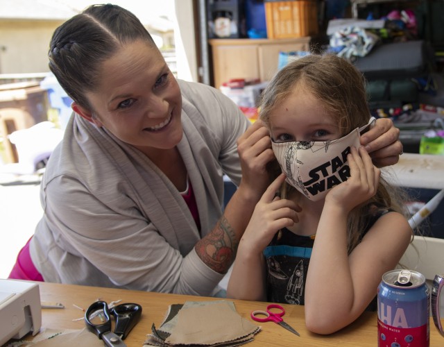Amber Gallagher and daughter Emeline, 7 show a Star Wars mask they made that was donated to a DoD civilian employee. 