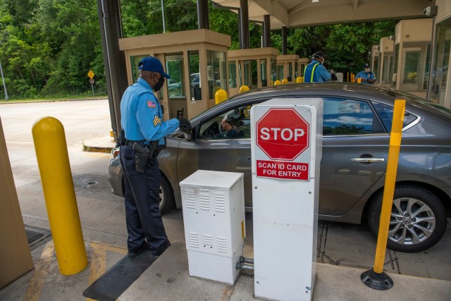 FORT BENNING, Ga. – At Fort Benning's main gate April 24, security guards check for proper identification of motorists seeking entry to the post. To minimize the spread of COVID-19, officials in March banned most visits, including those for...