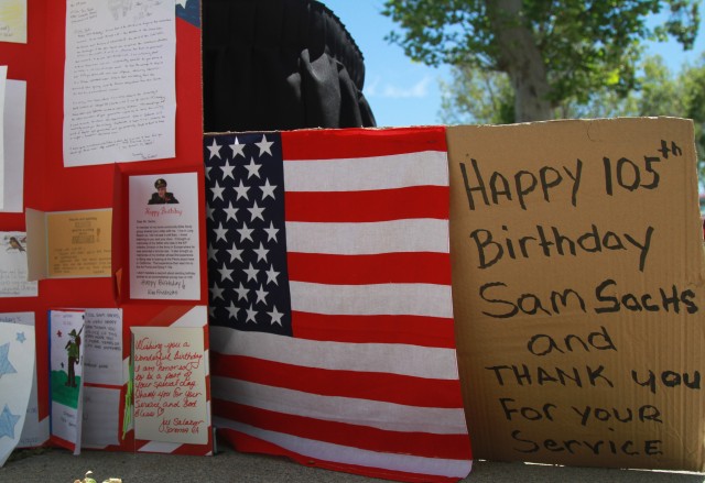 Birthday cards are displayed in the driveway and in front of the home of World War II veteran, Lt. Col. Sam Sachs, wishing him a happy 105th birthday, in Lakewood, Calif. on April 26, 2020.  The retired Army officer’s birthday was celebrated with a parade and a social distancing celebration.