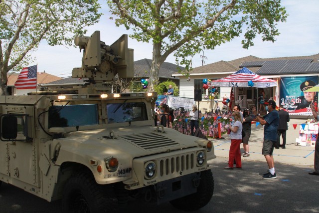 Soldiers from the California Army National Guard&#39;s 40th Infantry Division drive a M181 Humvee during a birthday parade for Lt. Col. Sam Sachs, a World War II veteran, during his 105th birthday celebration in Lakewood, California, on April 26, 2020. Sachs was an officer with the 325th Glider Infantry Regiment, 82nd Airborne Division and landed his glider on the beaches of Normandy during D-Day. 