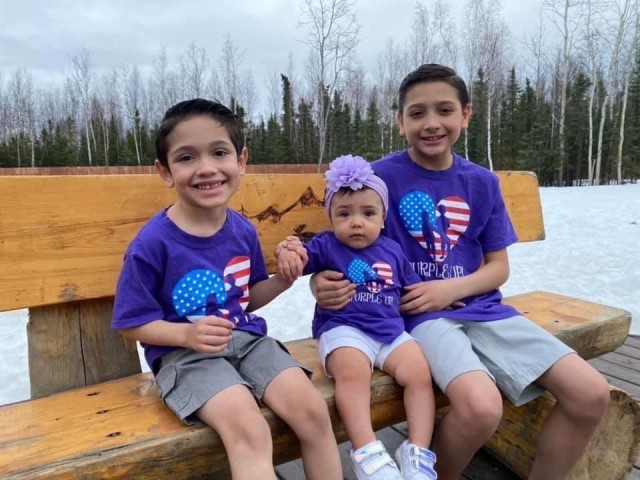 From left to right: Josean, Hope and Justin Galicia pose for a photo in honor of “Purple Up Day,” a virtual celebration of military families worldwide during the Month of the Military Child. Since April 1986, the Army has observed MOMC to recognize and honor the commitment, contributions and sacrifices military children make to our nation through the strength they provide our Soldiers and families.  