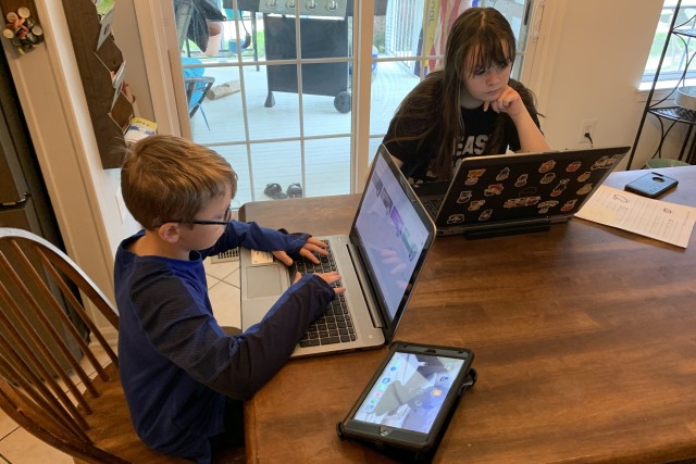 Jackson Doran and Mackenzie Doran work on schoolwork from their home in Md., April 28, 2020.
