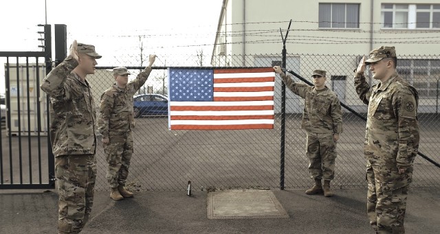 Members of the 522nd Military Intelligence Battalion, 207th Military Intelligence Brigade (Theater) conduct a reenlistment at the beginning of the COVID-19 precautionary measures.