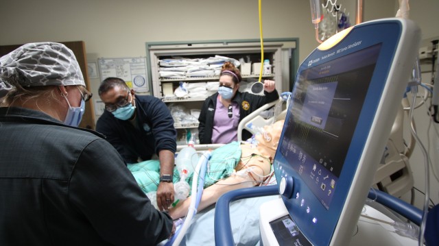 (From left) Capt. Arfan Malik, a critical care nurse at the Intensive Care Unit, Landstuhl Regional Medical Center, trains Samantha Johnson and Holly Bryant, both registered nurse with the Labor and Delivery Unit at LRMC, various training elements...