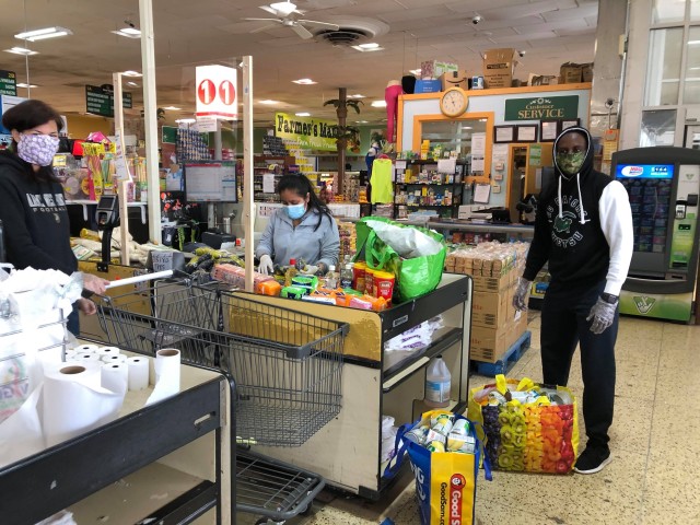 Class of 2023 Cadet Ruganzu Divin Mulisa from Rwanda helps bag groceries that were bought to help community families who lost their jobs.