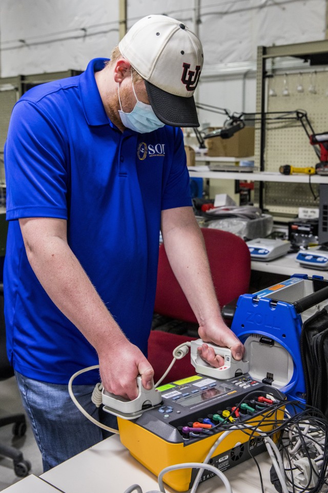 Shane Craig, a civilian employee at the Medical Equipment Concentration Site for the 88th Readiness Division, tests a Zoll defibrillator with a patient simulator while conducting preventive maintenance and repairs on medical equipment stored at the facility in Ogden, Utah, April 17, 2020. Soldiers and civilians working and volunteering at MECS 88 maintain and repair medical equipment in preparation to deploy it in support of Army Reserve medical units responding to the COVID-19 pandemic. (U.S. Army Reserve photo by Sgt. Jeremiah Woods)
