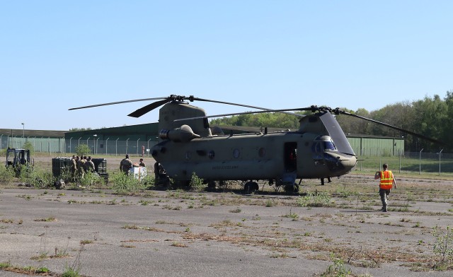 Team members at the U.S. Army Medical Materiel Center-Europe assist in unloading a Chinook helicopter carrying equipment for the 3rd Combat Aviation Brigade, 3rd Infantry Division on April 22. The 3rd CAB received dozens of mission-essential...