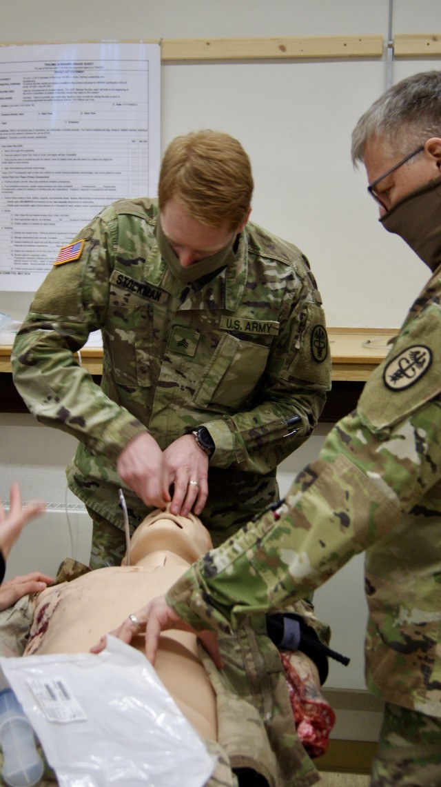 U.S. Soldiers, assigned to the U.S. Army Medical Department Activity Bavaria, examine a patient’s airway during training in Rose Barracks, Germany, April 21, 2020. Prior to inserting a nasal pharyngeal tube, medical providers examine their patient’s airway to ensure it is not blocked and safe to continue. (U.S. Army photo by Maj. John Ambelang)