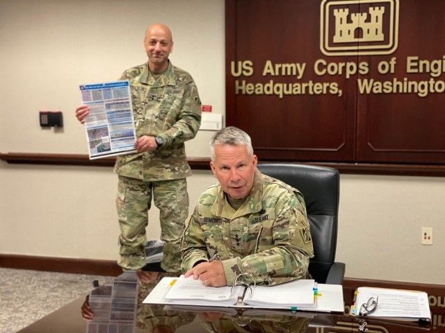 Lt. Gen. Todd Semonite, chief of engineers and U.S. Army Corps of Engineers commanding general, signs a Chief’s Report for the New York and New Jersey Harbor Anchorages Study at headquarters in Washington, April 23, 2020. Holding up the...