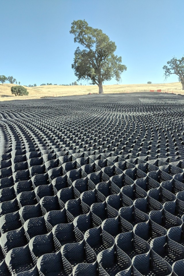 A pilot project was initiated by the Sustainable Range Program in coordination with the Cultural Resources Program to develop a method to sufficiently protect an archaeological site while allowing heavy vehicles to maneuver on top. A one acre archaeological site was capped using a geotextile blanket and a cellular confinement system (pictured here) and filled with sterile soil to provide a stable ground surface strong enough to support heavy armored and tracked military vehicles for off-road maneuver training. The archaeological site is located in a critical narrow pass between two open maneuver areas that was previously blocked from vehicle movement. Capping allows for ease of vehicle movement between the two areas at the same time protecting the resource.
