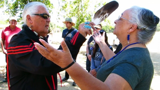 Members of the Xolon Salinan tribe participate in a smudging purification ceremony before they visit Stony Valley, located on Fort Hunter Liggett, in June 2018. Tribal member Bobby Sims uses an eagle feather to waft the sage smoke onto Donna Haro,...