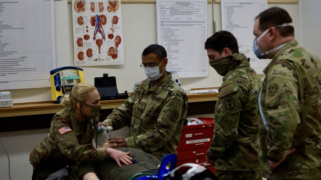 U.S. Soldiers discuss and practice intubating a simulated patient during training in Rose Barracks, Germany, April 21, 2020. Intubating a patient is a lifesaving measure that provides air to a patient in respiratory distress. (U.S. Army photo by Maj. John Ambelang)