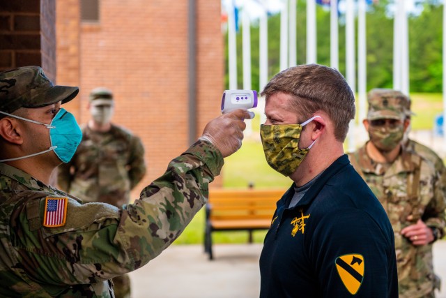 FORT BENNING, Ga. - Secretary of the Army Ryan McCarthy has his temperature taken at 30th Adjutant Battalion (Reception) during his visit to the Maneuver Center of Excellence April 29.  (U. S. Army photo by Patrick A. Albright, Maneuver Center of Excellence Photographer)