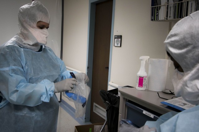 Dorothy Hall, critical care nurse at Landstuhl Regional Medical Center, dons personnel protective equipment during COVID-19 operations at LRMC’s Intensive Care Unit, April 1. Health care personnel across LRMC are on the front lines for preventing the spread of COVID-19 as they continue providing patient care.