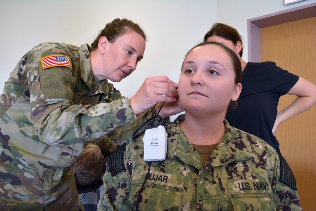 Capt. Theresa Galan, an audiologist assigned to Landstuhl Regional Medical Center, demonstrates how to properly operate the probe assembly for the titan, a piece of diagnostic audiologigy equipment that can perform biological assessments of the middle and inner ear.  Galan gave a presentation Sept. 11 during the Virtual Health Patient Presenter Training Course at Landstuhl.  The course instructed participants on required virtual health presentation skills across 12 specialties.