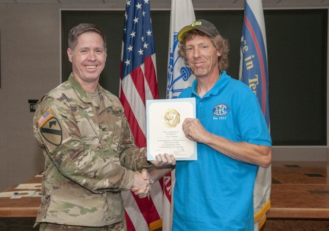Cory Hubbard, an engineer and lead test officer for Direct Fire testing at U.S. Army Aberdeen Test Center (ATC), is presented a letter and pin for 30 years of federal service from ATC commander, COL John Hall, May 2019. Hubbard is the recipient of the 2019 National Defense Industrial Association Army Government Civilian Tester of the Year, recognizing his contributions to the professional discipline of test and evaluation.