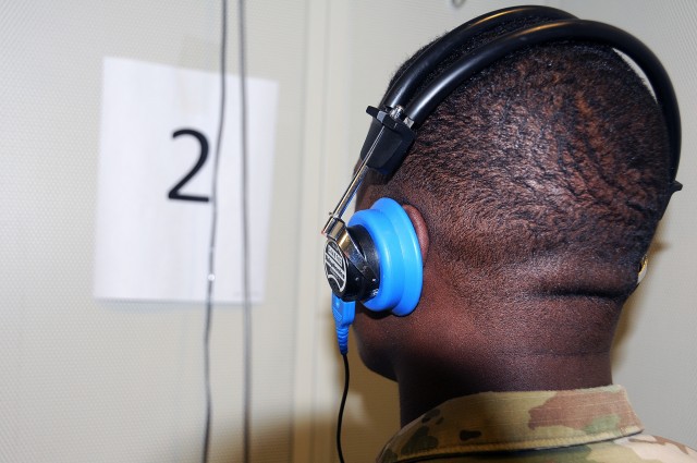 A Soldier listens for audio tones during a hearing test at Joint Base McGuire-Dix-Lakehurst, New Jersey. 