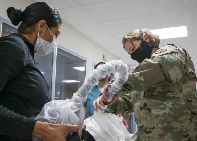 Medical personnel at Landstuhl Regional Medical Center familiarize themselves with the Powered Air-Purifying Respirator System, to advance COVID-19 patient care and gain experience with donning, doffing and using the PAPR system at LRMC, April 28.