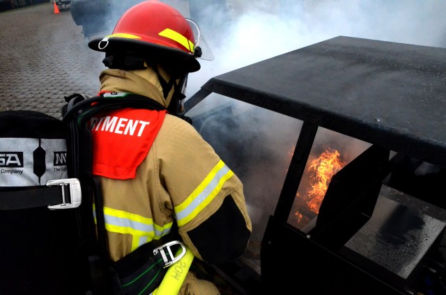 A firefighter from the U.S. Army Garrison Rheinland-Pfalz trains to put out a car fire using the garrison's new Hose Line Training Aid System. Training chiefs can switch out different training aids to simulate fires with propane tanks, barbecue...
