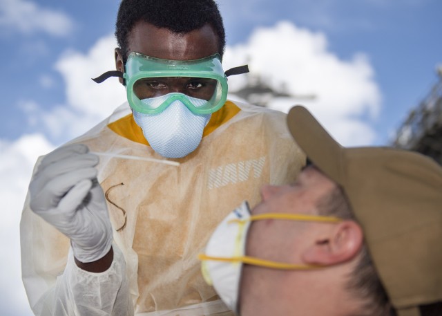 200422-N-CH038-1064 APRA, Guam (April 22, 2020) U.S. Navy Hospitalman Christian Akins, from Atlanta, assigned to Naval Hospital Guam, takes a nasal sample from a U.S. Sailor assigned to the aircraft carrier USS Theodore Roosevelt (CVN 71) as part...