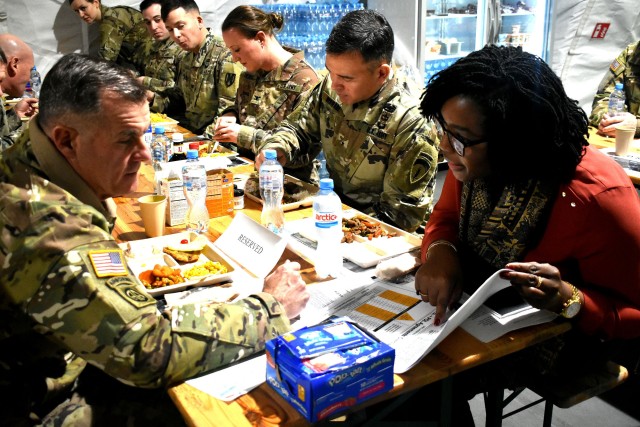 Clarissa Lane, chief of international agreements for U.S. Army Europe, briefs Lt. Gen. Charless A. Flynn, Headquarters Department of the Army, G-3/5/7 (operations, plans, and training), and his staff during his visit to Powidz, Poland. (Photo by Maj. Olha Vandergriff) 