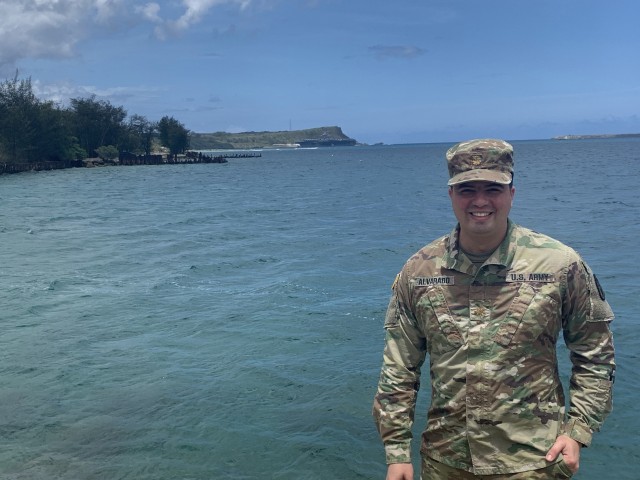 Army Maj. (Dr.) Gadiel Alvarado, infectious diseases physician, poses for a photo in Guam with the USS Theodore Roosevelt (CVN 71) in the background April 18, 2020. Alvarado served as the infectious disease expert for the COVID-19 Public Health...
