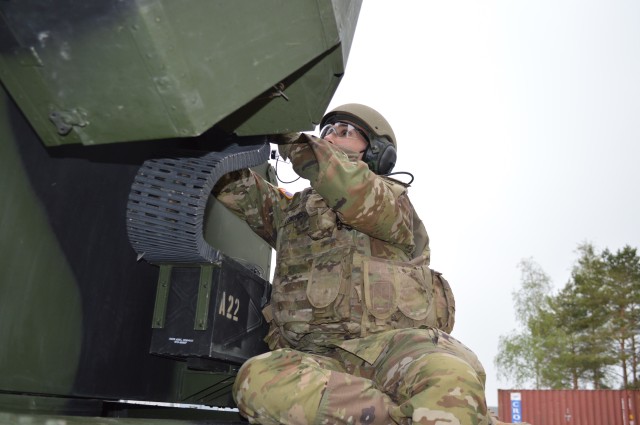 Sgt. Anthony Longres, 5th Battalion, 4th Air Defense Artillery Regiment, 10th Army Air & Missile Defense Command, air and missile defense crewmember, loads M3P .50 caliber machine gun ammunition onto an Avenger short-range air defense missile system on Shipton Kaserne Apr. 30 during training. The crews are maintaining their combat proficiency in a COVID-19 environment.