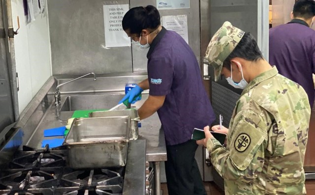 U.S. Army Spc. Raymond Cabusao, Public Health Activity-Guam veterinary food inspection specialist, conducts a food inspection at King's Restaurant, Tamuning, Guam, April 2020. King’s Restaurant is one of the facilities providing food to Sailors...