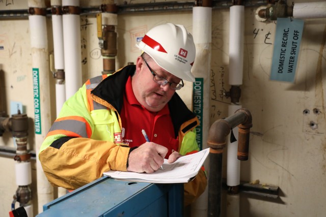 Brian Erbstosesser, fire protection engineer, U.S. Army Corps of Engineers – Omaha District, takes notes about a water supply system during a site assessment of a building in Omaha, Neb., the state is considering turning into an alternate care...