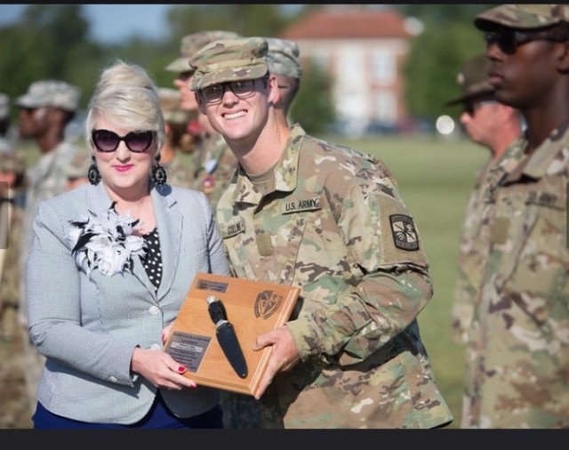 Cadet William Collins receives the Bold Leader Spirit Award, during his Advanced Camp graduation in Fort Knox, Ky.
