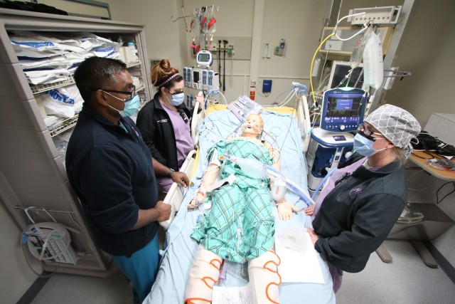 (From left) Capt. Arfan Malik, a critical care nurse at the Intensive Care Unit, Landstuhl Regional Medical Center, trains Samantha Johnson and Holly Bryant, both registered nurse with the Labor and Delivery Unit at LRMC, various training elements designed to increase staffing capabilities in support of COVID-19 operations at LRMC, April 20. Health care professionals throughout LRMC are undergoing critical care training as part of larger efforts to increase staff readiness and development.