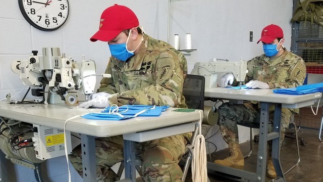 Soldiers assigned to Group Support Battalion, 20th Special Forces Group (Airborne) assist with COVID-19 response efforts making personal protective face masks in Birmingham, Alabama, May 1, 2020. The GSB Riggers shifted their focus from parachute operations to full production of personal protective equipment in support of COVID-19 response. The masks will be distributed to the Joint Forces Headquarters in Montgomery, Alabama to be disseminated to disinfection and medical teams across the state working on COVID-19 response missions. (U.S Army photo by Sgt. 1st Class Brian Cox)