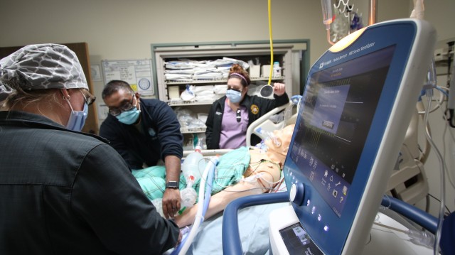 (From left) Capt. Arfan Malik, a critical care nurse at the Intensive Care Unit, Landstuhl Regional Medical Center, trains Samantha Johnson and Holly Bryant, both registered nurse with the Labor and Delivery Unit at LRMC, various training elements designed to increase staffing capabilities in support of COVID-19 operations at LRMC, April 20. Health care professionals throughout LRMC are undergoing critical care training as part of larger efforts to increase staff readiness and development.