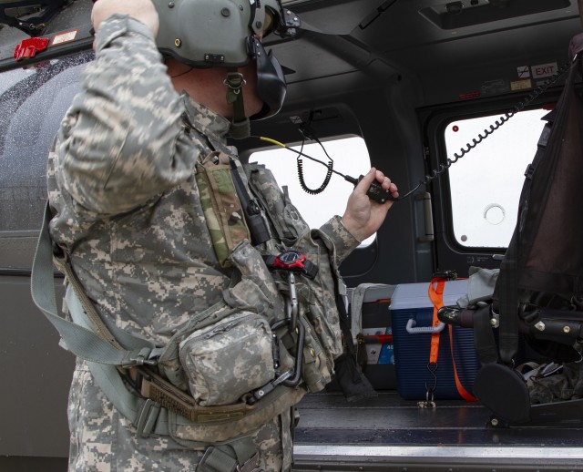 Sgt. Jason Humke, a helicopter maintainer with Company A, 1st Battalion, 376th Aviation Security and Support, Iowa Army National Guard, performs pre-flight operations of a UH-72 Lakota helicopter during a mission in Sioux City, Iowa, on May 4, 2020. COVID-19 test kits from a Test Iowa site in Sioux City, Iowa, were flown to the State Hygienic Laboratory in Coralville, Iowa. (U.S. Army National Guard photo by Cpl. Samantha Hircock)