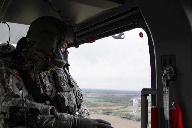 Sgt. Jason Humke, a helicopter maintainer, with Company A, 1st Battalion, 376th Aviation Security and Support, Iowa Army National Guard, in a UH-72 Lakota helicopter over Waterloo, Iowa, on May 4, 2020. COVID-19 test kits from a Test Iowa site in Sioux City, Iowa, were transported by helicopter to the State Hygienic Laboratory in Coralville, Iowa. (U.S. Army National Guard photo by Cpl. Samantha Hircock)