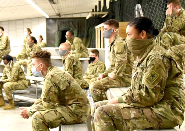 Advanced Individual Training Soldiers listen to a virtual in processing briefing in the US Army Garrison Rheinland-Pfalz Deployment Processing Center. AIT Soldiers on their way to their assignments throughout Germany are being housed by USAG RP for their 14 day quarantine period, as required by the host nation.