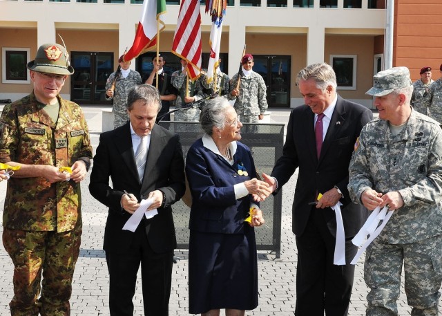 Paola Del Din, Italian Gold Medal for Valor recipient and sister of Gold Medal for Valor (posthumous) recipient 1st. Lt. Renato Del Din for whom Caserma Del Din is named, shakes hands with U.S. Ambassador to Italy David Thorne immediately after...