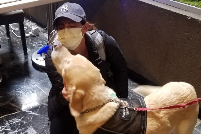 A healthcare nurse greets a therapy dog at the Javits New York Medical Station after her work shift in New York City April 17, 2020. The dogs, trained through the organization “Puppies Behind Bars” where dogs are trained in state correctional...