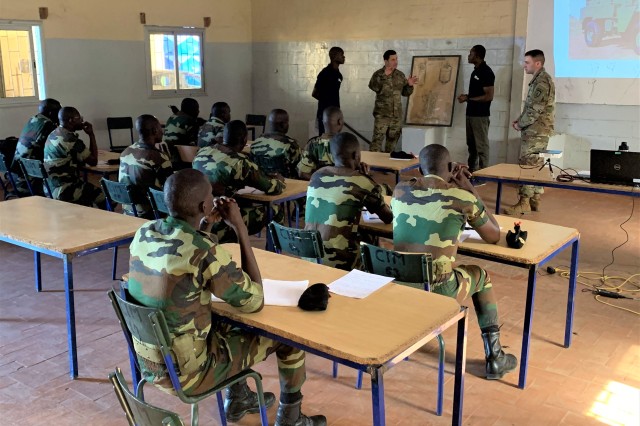 Chief Warrant Officer 3 Yagmur Saylak, center, and Staff Sgt. Braxton Pernice, right, from Logistics Advisor Team 1610, 1st Security Force Assistance Brigade, discuss the importance of conducting preventive maintenance with Armed Forces of Senegal...