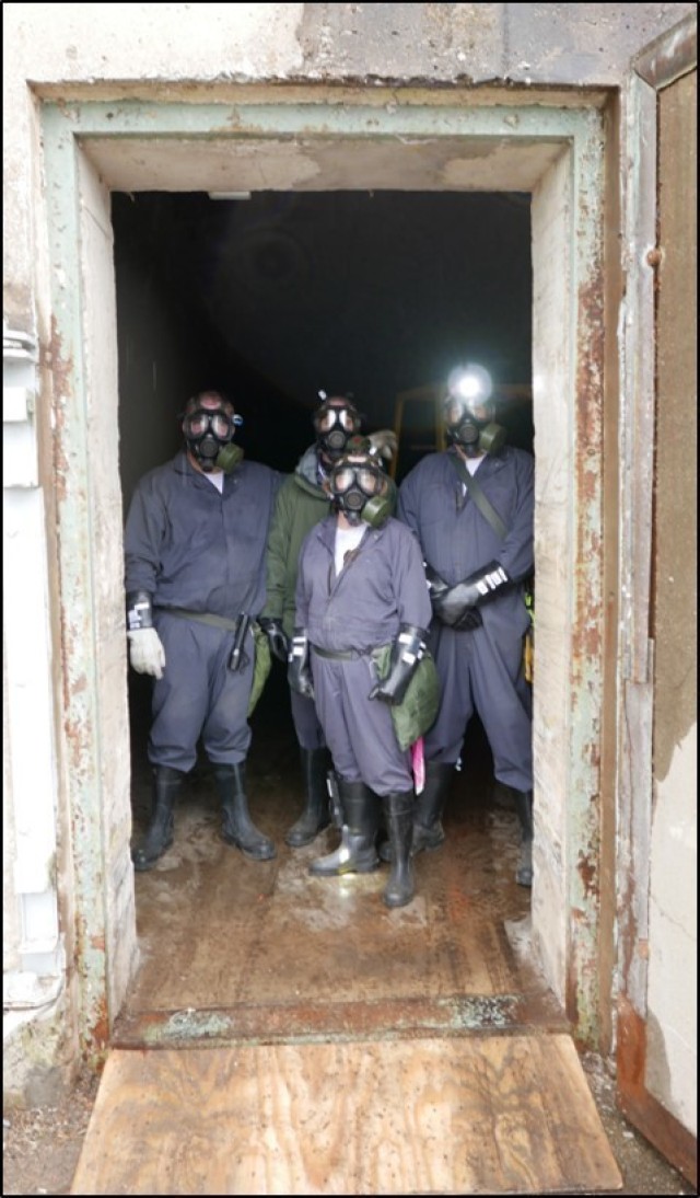 BGCA personnel stand in the last GB projectile earth-covered magazine, now emptied of munitions.
